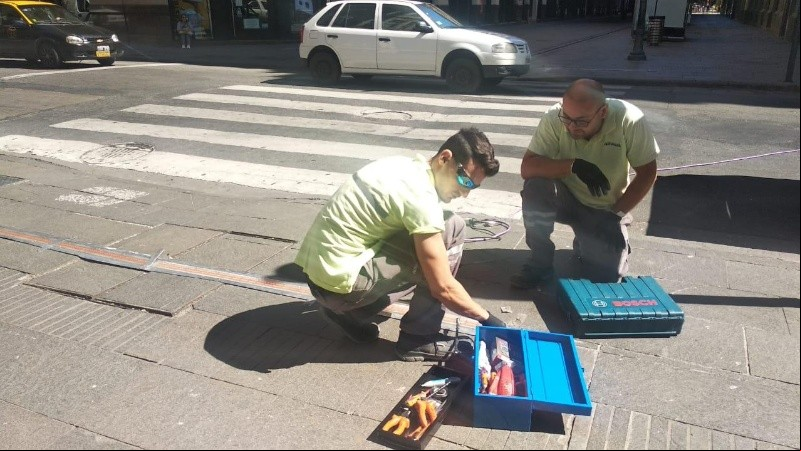 Los operarios arreglando el semáforo de pie este sábado. 