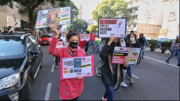 Manifestantes con su cartel de protesta.