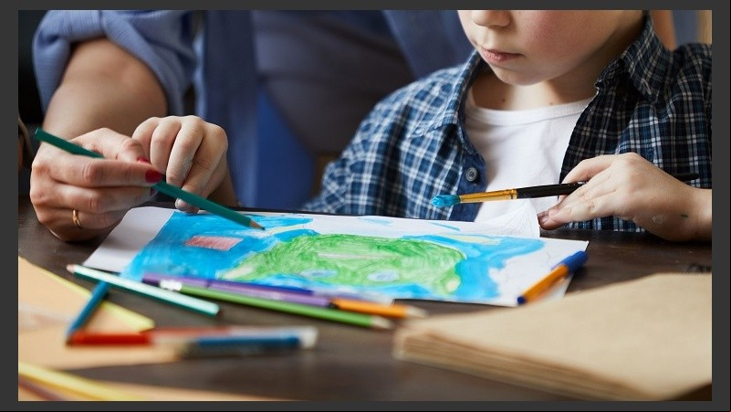 Closeup of Boy Drawing Pictures with Mom