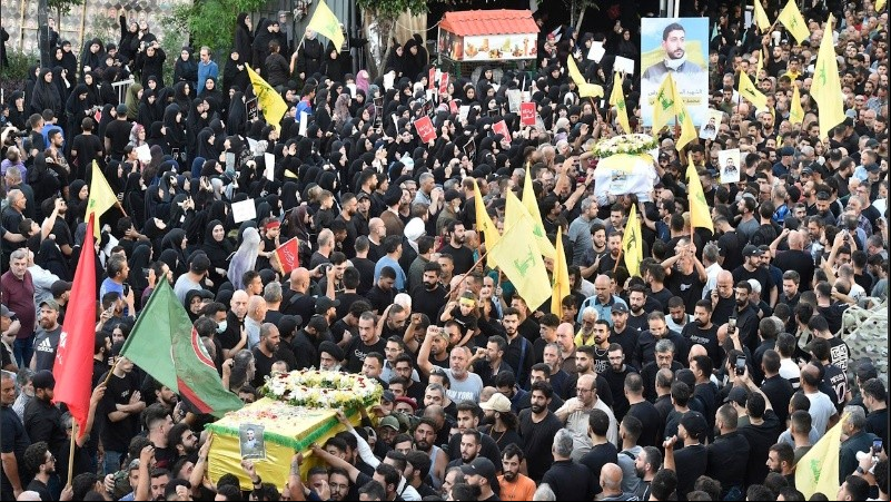Los dolientes llevan los ataúdes de las personas que murieron un día antes en explosiones de buscapersonas, durante la procesión fúnebre en el suburbio sur de Beirut, Líbano, el 18 de septiembre de 2024.